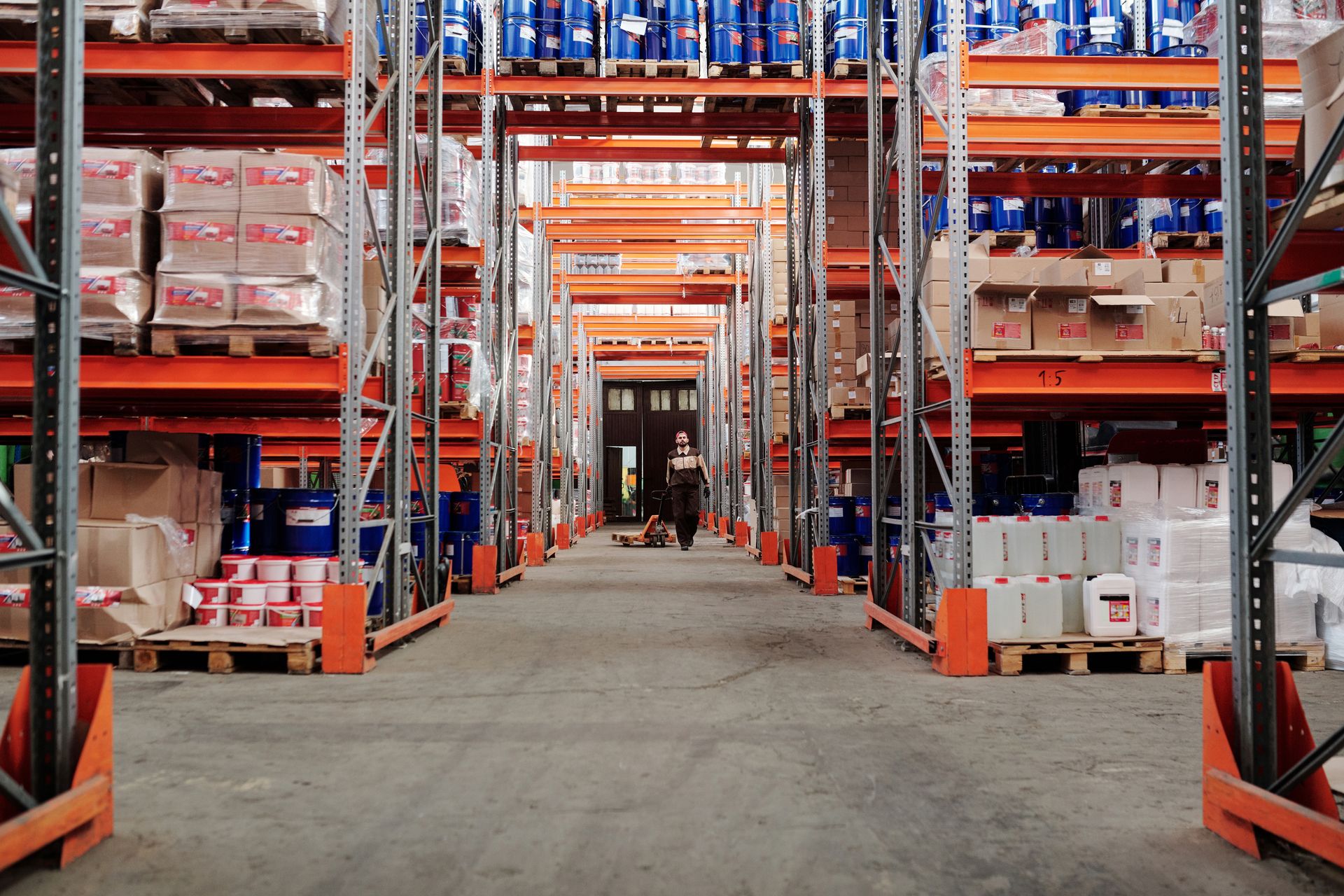 Warehouse aisle lined with tall pallet racking