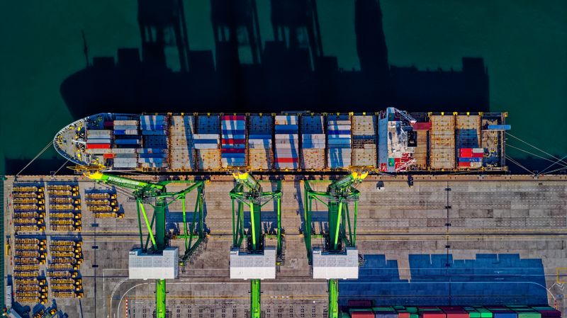Cranes loading a container ship at the quay